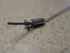 Photo of ferrule and screw used as cable stop
