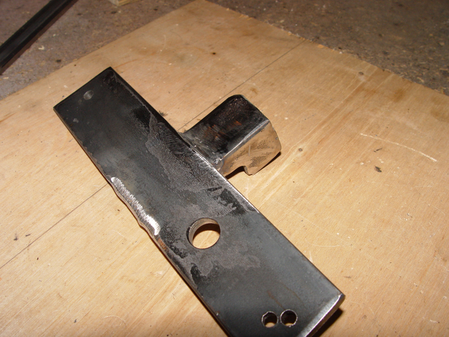 Photo of ratchet stop welded to mounting bar